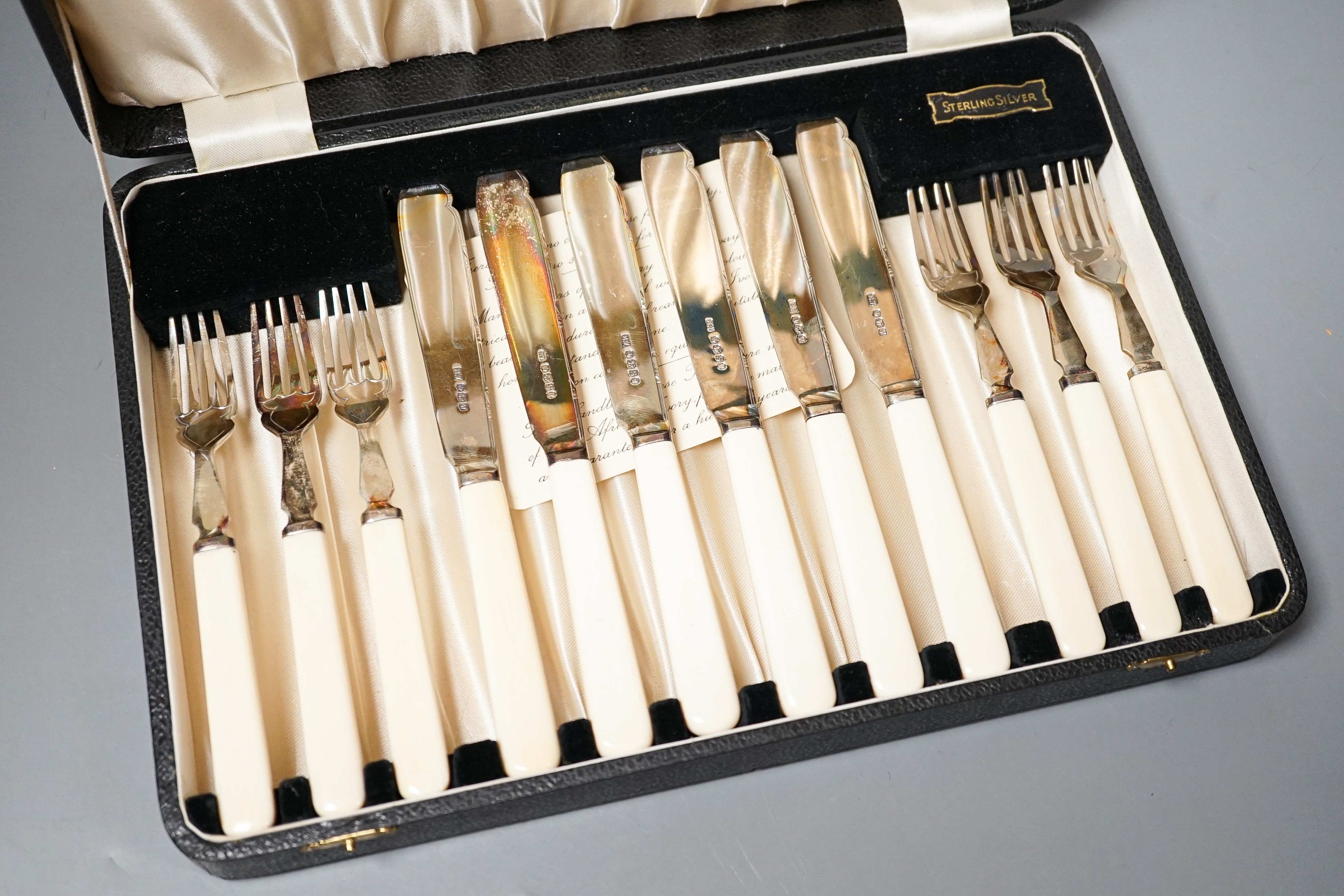 A 1930's cased set of six pairs of ivory handled silver dessert eaters by Viners Ltd, Sheffield, 1936/8/9, gross weight 13.5oz.